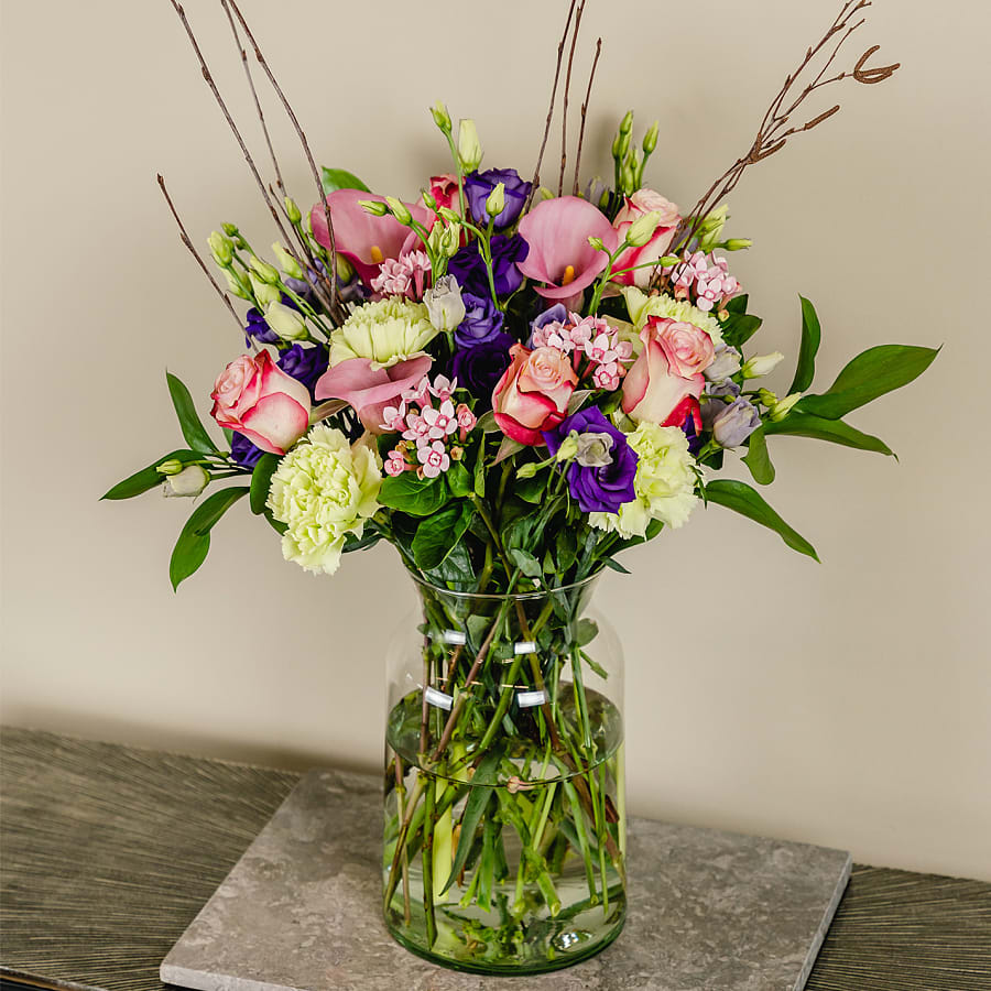 Pink Calla Lillies, Sweetness Roses, Green Carnations, Pink Bouvardia, Purple Lisianthus, Ruscus and natural Birch